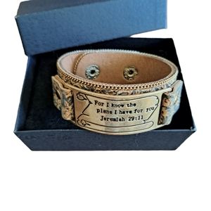 Ladies bracelet.  Snap closure with 2 lengths, faux leather strap.